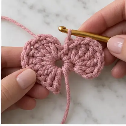 Two rounded crochet heart lobes formed around one ring