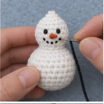 Embroidering the face of a crochet snowman
