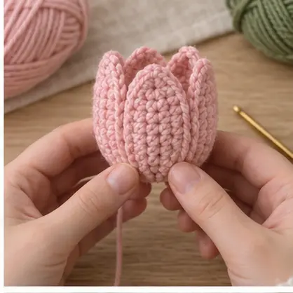 Crochet tulip petals folded around the top of a flower cup