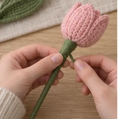 Attaching a crochet tulip flower and leaf to a green wrapped stem