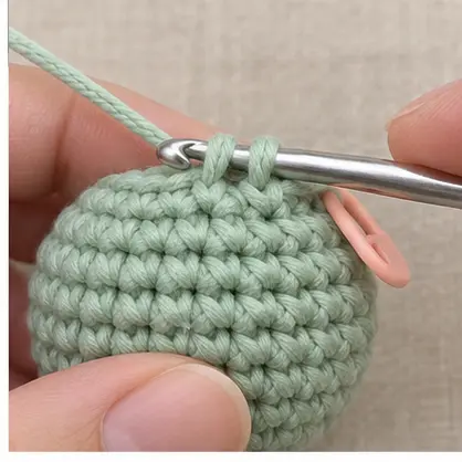 Crochet hook passing under two adjacent front loops