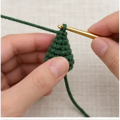 Small green crochet cone growing from its pointed top
