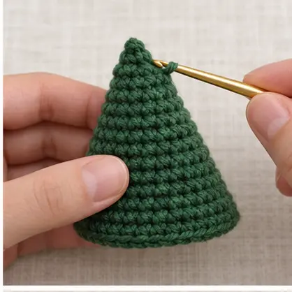 Completed forest green crochet cone for a Christmas tree