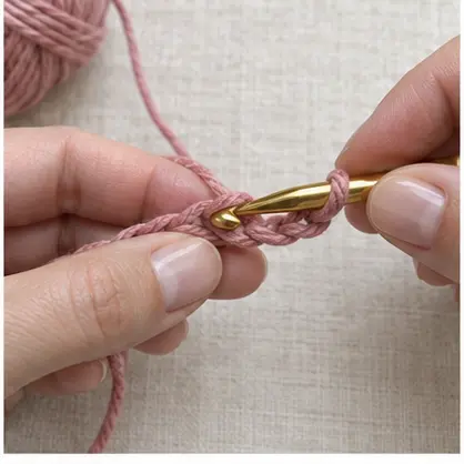 Crochet hook entering the second chain from the hook