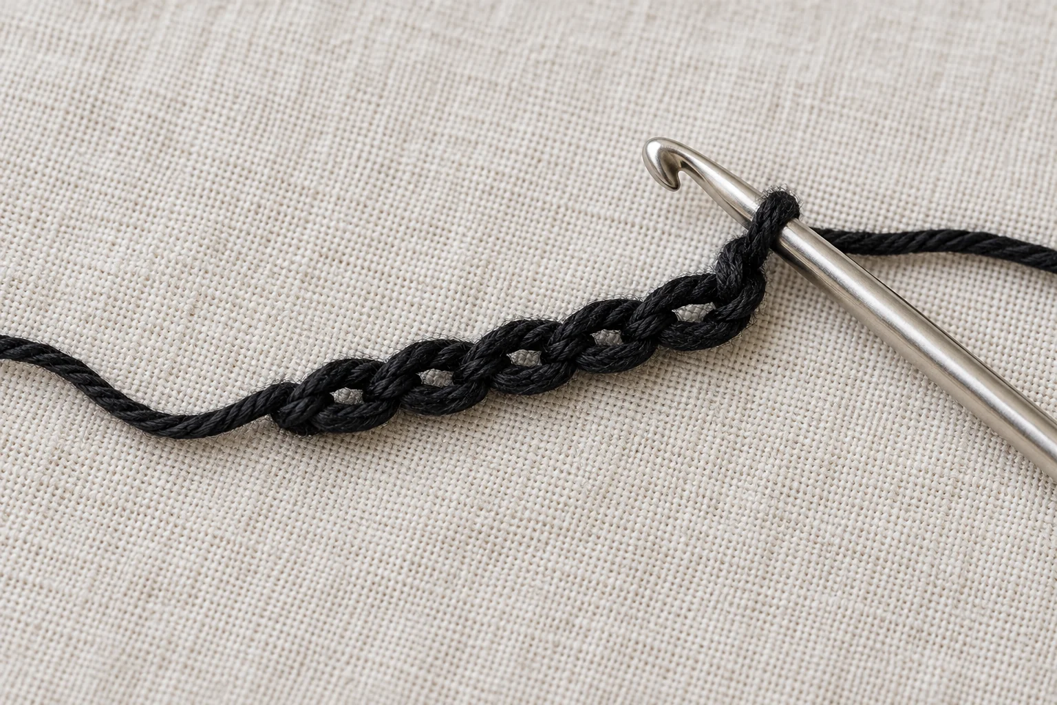 Black foundation chain with crochet hook