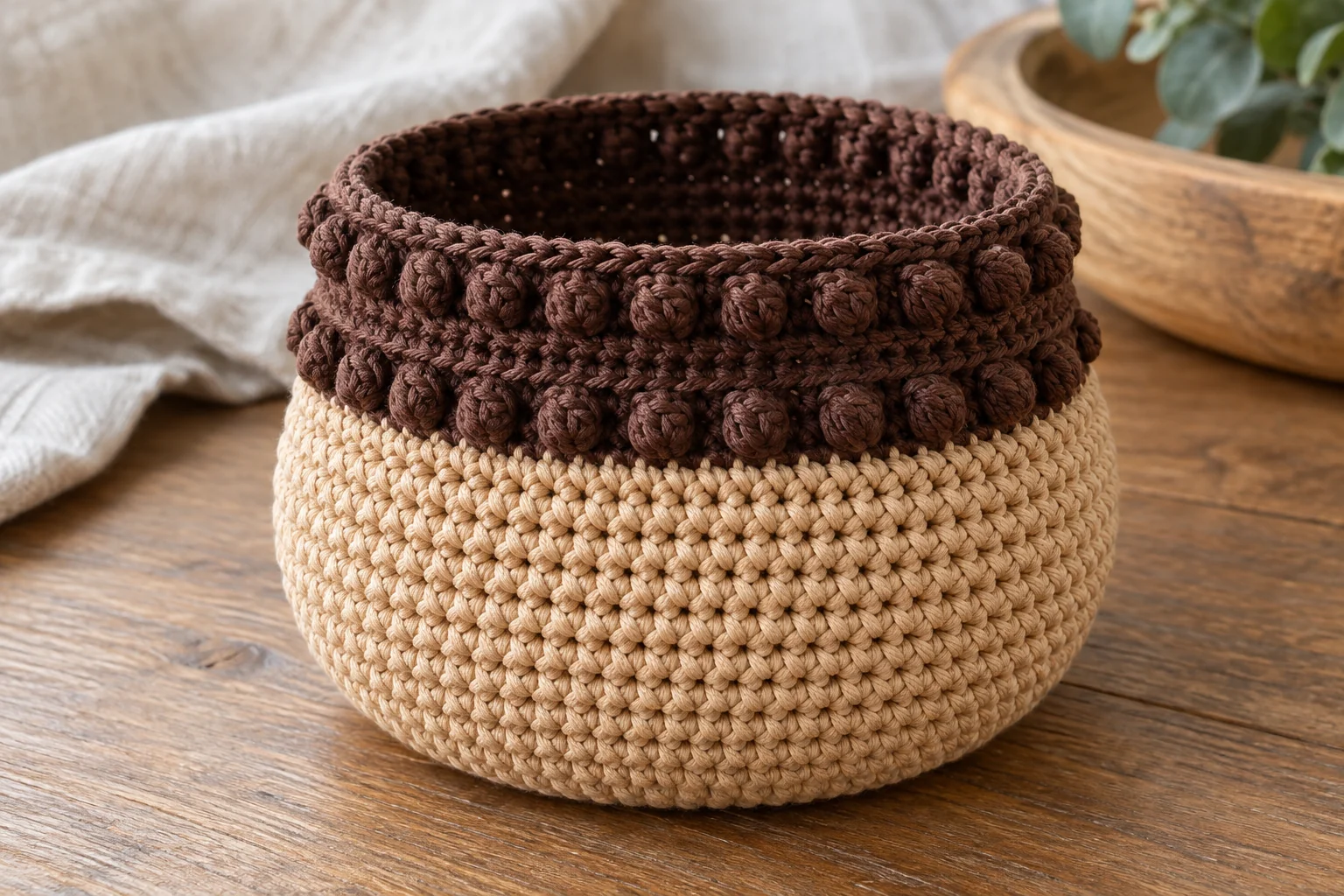 Brown bobble stitch cap attached to a tan crochet pouch