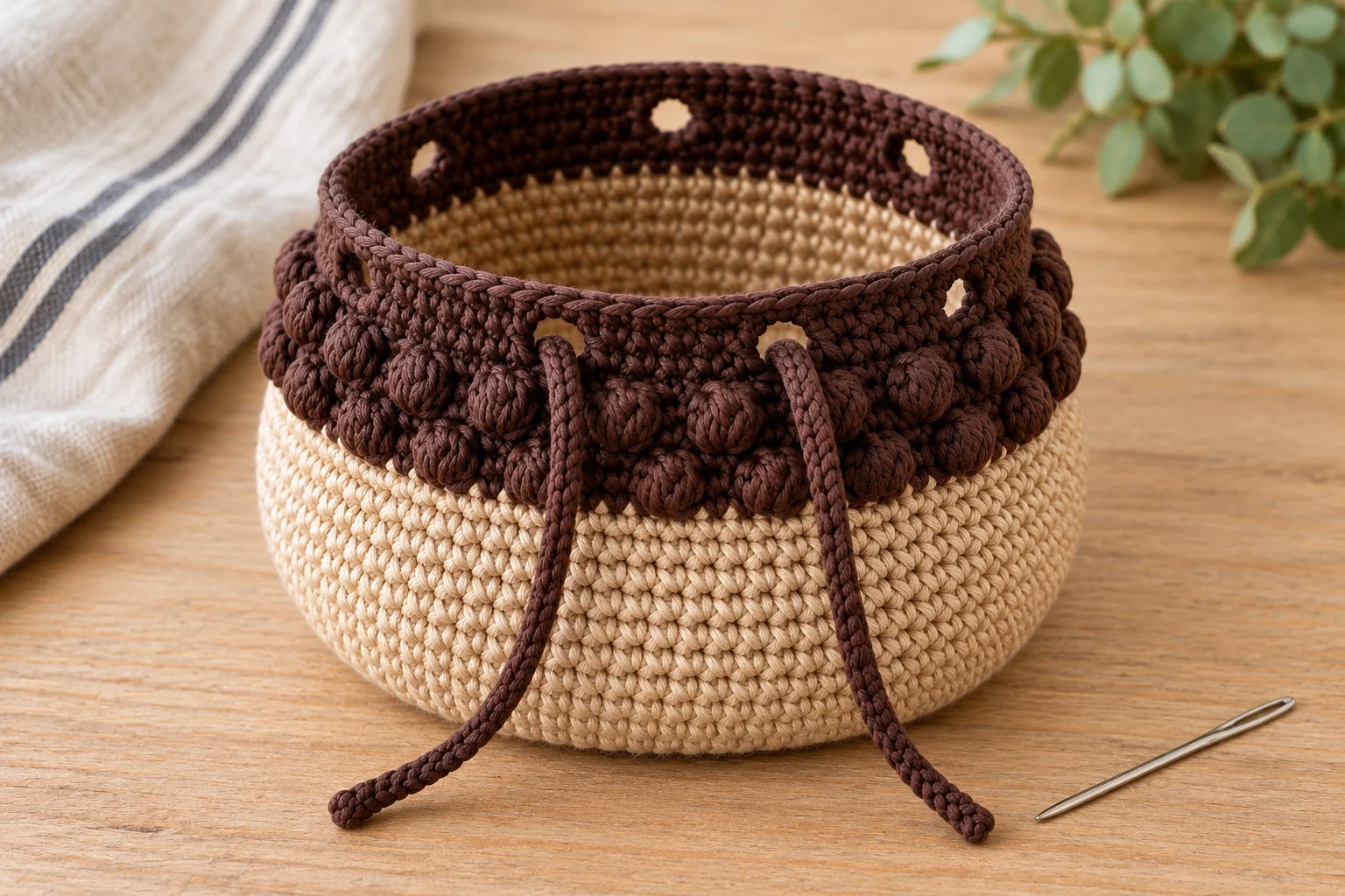Brown crochet drawstring threaded through the acorn pouch eyelets