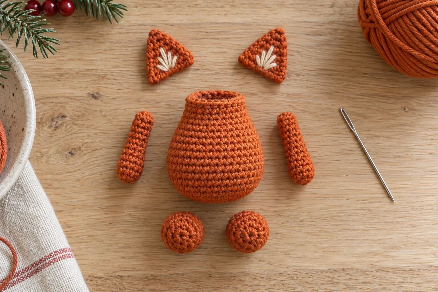 Crochet fox body, two ears, two arms, and two feet before assembly