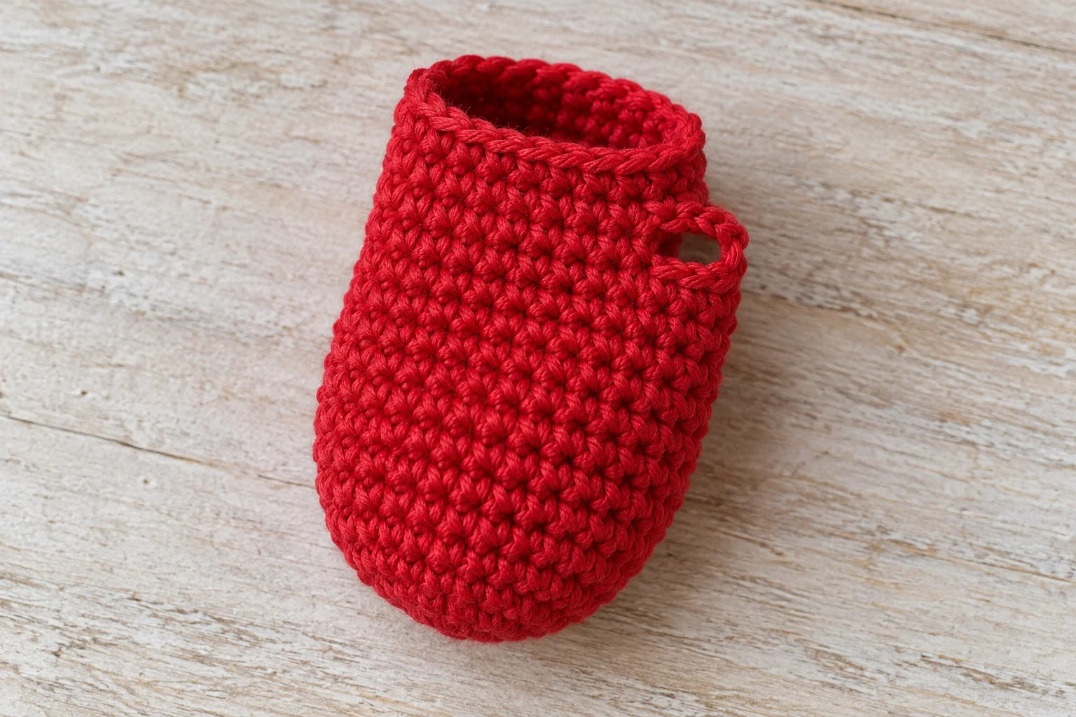 Red crochet mitten hand with a small thumb opening