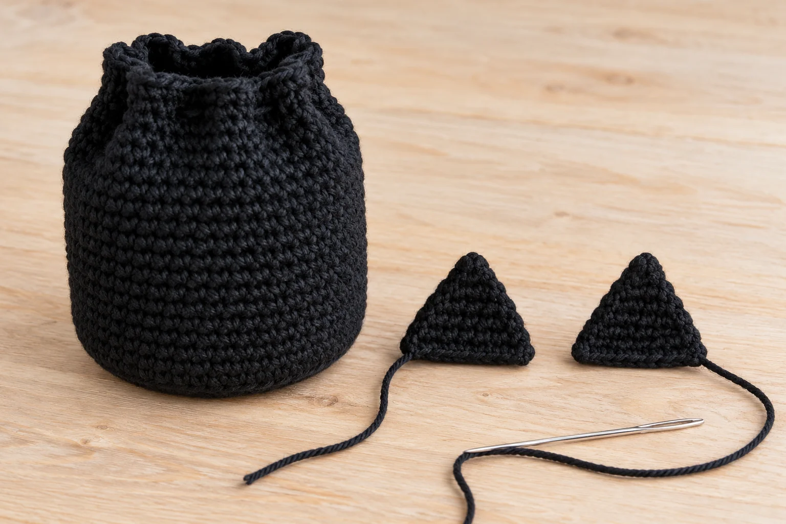 Two triangular crochet cat ears before sewing