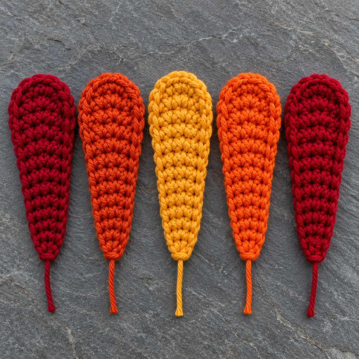 Five loose crochet turkey tail feathers in autumn colors